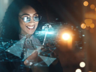 lady wearing glasses smiles at phone